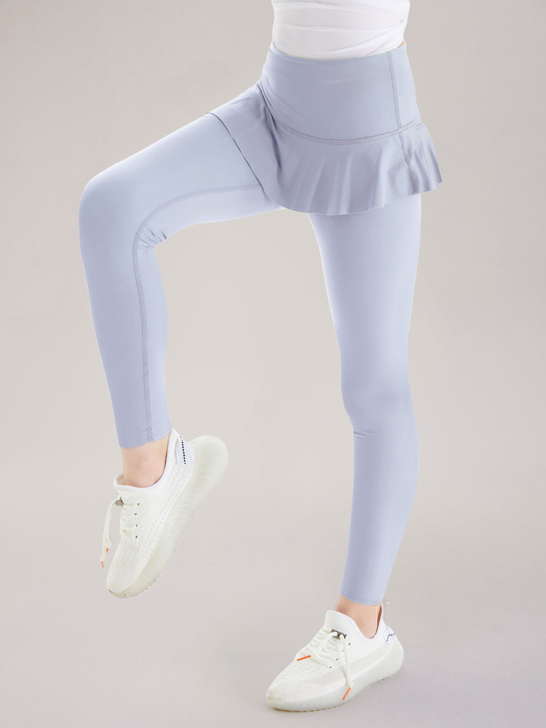 Leggings con cintura alta y falda con volantes